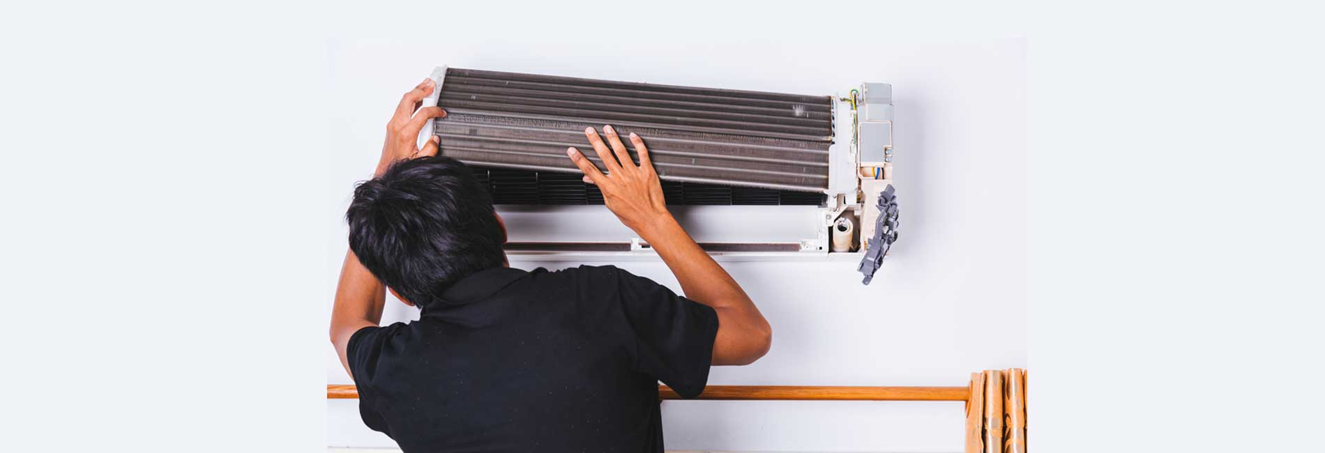 Technician performing AC maintenance